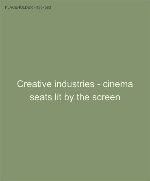 Cinema seats lit by the screen, representing the creative industries sector